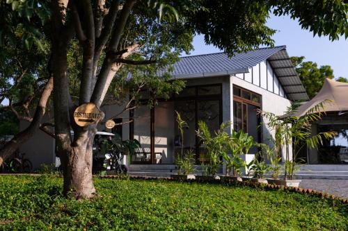 a house with a sign on a tree at The Alampara Resort - Luxury Boutique Glamping & Water sports in Cheyūr