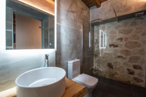 a bathroom with a white sink and a toilet at Xigia Escape villas in Khartáta