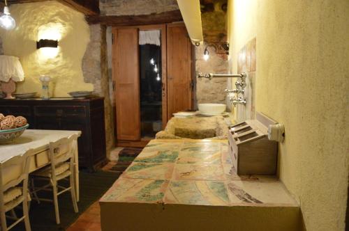 a room with a table, chairs and a bed at Casa Antica in Castiglione dʼOrcia
