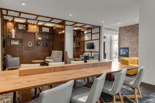 a living room with a large wooden table and chairs at Hyatt Place Colorado Springs Downtown in Colorado Springs