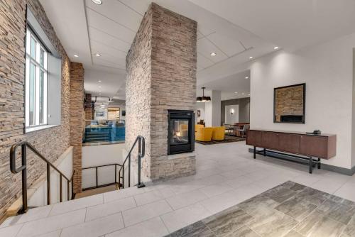 a lobby with a brick fireplace and a bench at Hyatt Place Colorado Springs Downtown in Colorado Springs