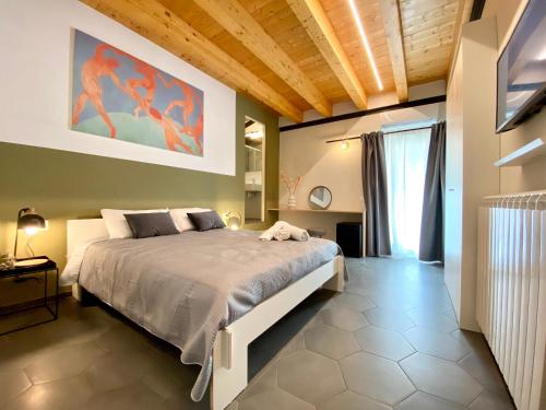 a bedroom with a bed and a painting on the wall at B&B ALIVA in Alcamo