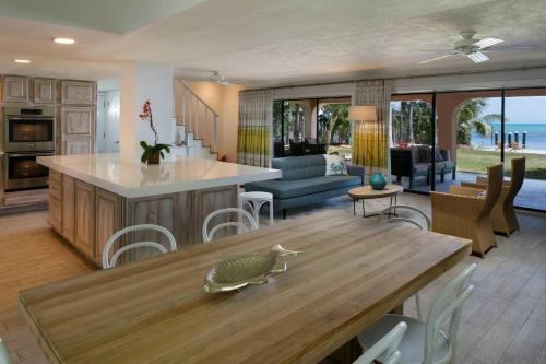 a kitchen and living room with a table and a couch at La Siesta Resort & Villas in Islamorada