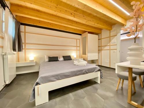a bedroom with a bed and a table and a chair at B&B ALIVA in Alcamo