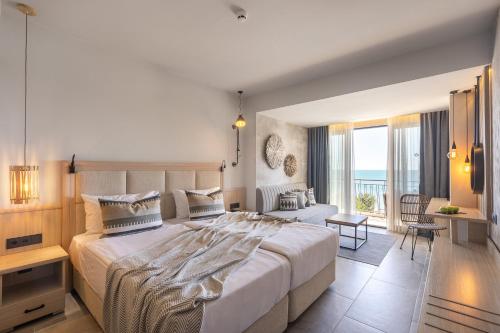 a bedroom with a large bed with a view of the ocean at Grifid Vistamar Hotel - 24 Hours Ultra All inclusive & Private Beach in Golden Sands