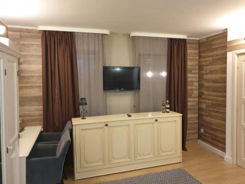 a living room with a couch and a flat screen tv at Bizant Boutique in Bacău