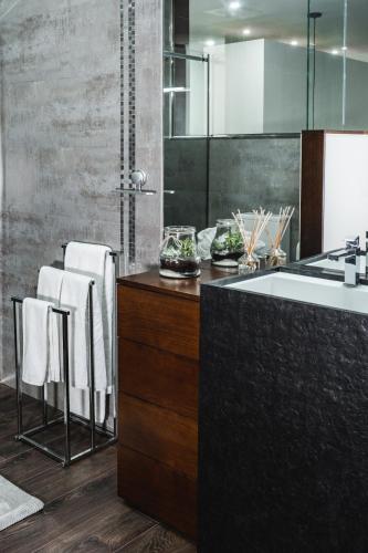a bathroom with a sink and some white chairs at O Pouso dos Pousos in Mesão Frio
