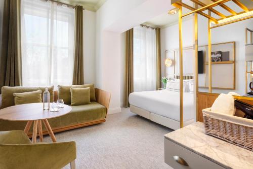 a living room with a couch and a bed at Meliá London Kensington Member of Meliá Collection in London