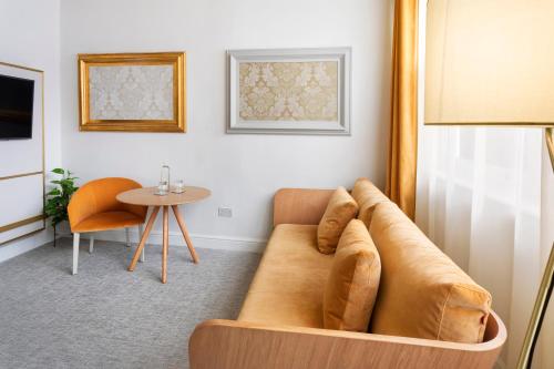 a living room with a couch and a table at Meliá London Kensington Member of Meliá Collection in London