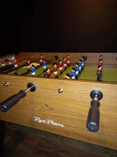 a wooden table with a chess board with dolls on it at Cocottes & Colibri in Châtellerault