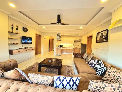 a living room with a couch and a table at Executive Apartments In Bahria Heights in Rawalpindi