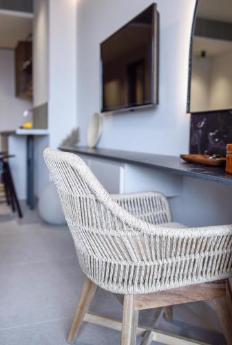 a wicker chair sitting in front of a counter at ANASSA BUTIK LIVING NIKITI in Nikiti