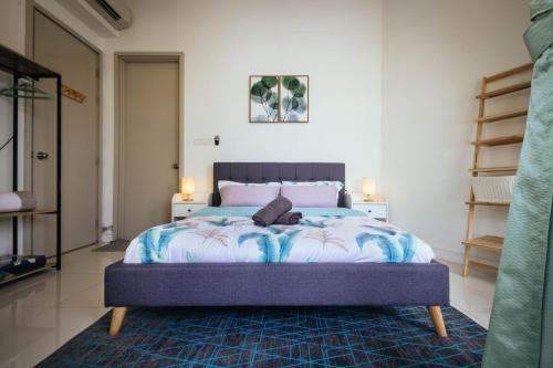 a bedroom with a bed with a blue comforter at Marina Times Square Homestay by Evernent in Miri