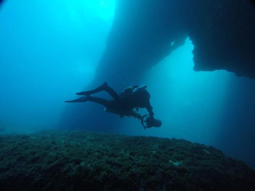 a person is swimming in the ocean under the water at Radisson Blu Resort, Malta St. Julian's in St Julian's
