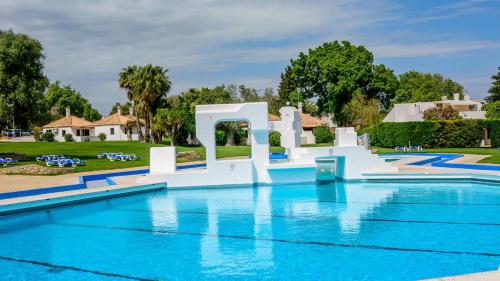 a pool at a resort with a water slide at Beach House Pedras D'el Rei in Santa Luzia