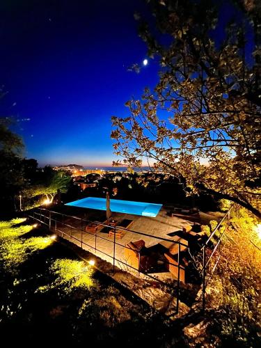 a building with a swimming pool at night at Torre Scribanti in Sestri Levante