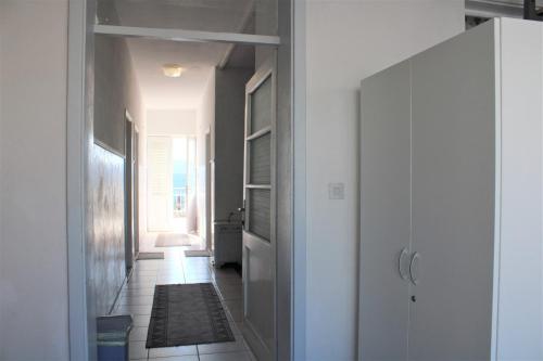 a hallway with a door to a room with a rug at Apartment Dora in Neum