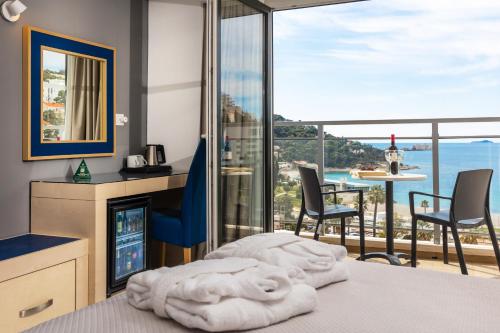 a bedroom with a bed with a view of the ocean at Grand Hotel Park in Dubrovnik