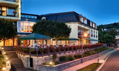 a group of people sitting outside of a building at Hotel Weis in Mertesdorf