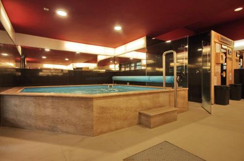 a jacuzzi tub in a large room with at Hotel Corvin in Gyula