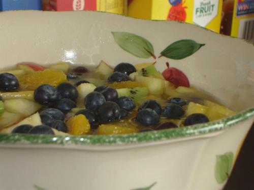a bowl of fruit with blueberries and other fruits at Glanllifon B&B in Criccieth