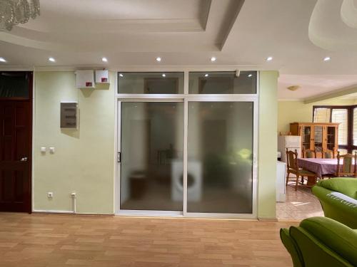 a living room with a sliding glass door at Huge Apartment with a Garden in the City Center in Pristina