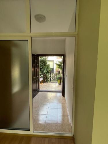 a view of a hallway with a door into a room at Huge Apartment with a Garden in the City Center in Pristina