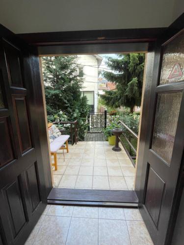a door leading to a patio with a porch at Huge Apartment with a Garden in the City Center in Pristina