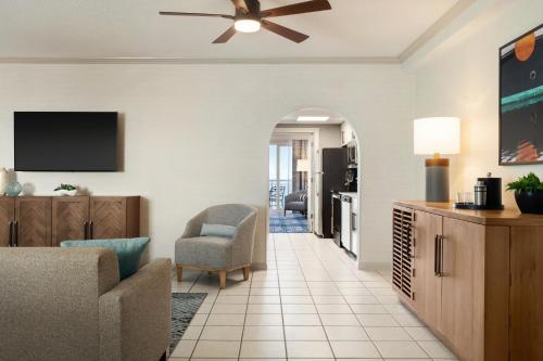 a living room with a couch and a ceiling fan at Holiday Inn & Suites Ocean City by IHG in Ocean City