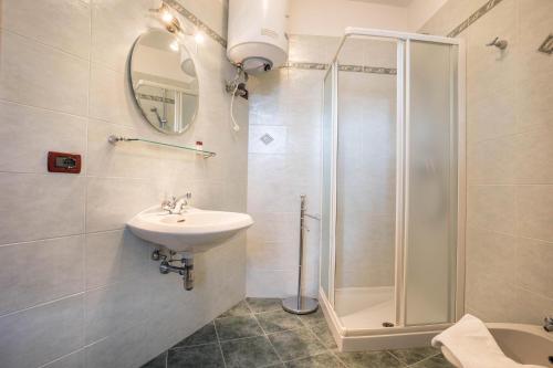 a bathroom with a sink and a shower at Residence Lena App 3 with Balcony in Tenno