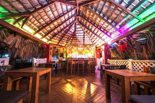 a restaurant with tables and chairs and a wooden ceiling at Casa Azul Las Galeras in Las Galeras