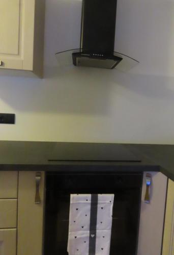 a kitchen with a stove top oven with a microwave at Cuore nel Borgo in Borgo