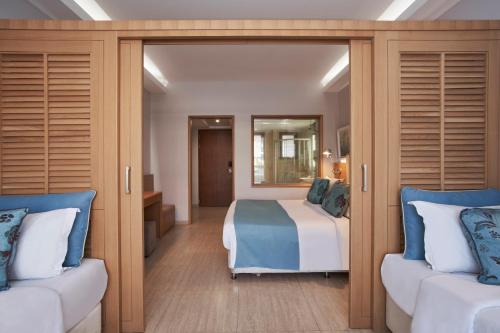 A bed or beds in a room at Atlantica Holiday Village Rhodes