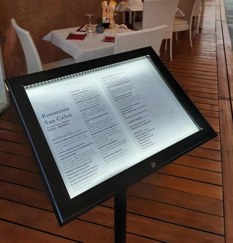 a menu on a sign on a table in a restaurant at Hotel Ristorante San Celso in Varazze
