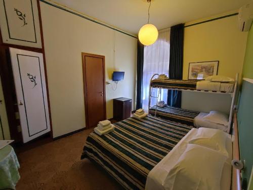 a bedroom with a bunk bed and a mirror at Hotel Le Grazie in Portovenere
