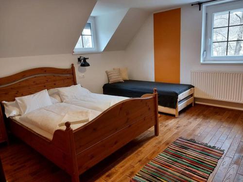 a bedroom with two beds and a large window at Szilvásvárad Camping & Apartman in Szilvásvárad