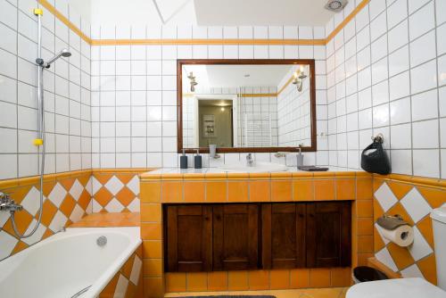 a bathroom with a sink and a mirror and a tub at A Diamond of 140 m2 in Platonas Ancient Athens in Athens