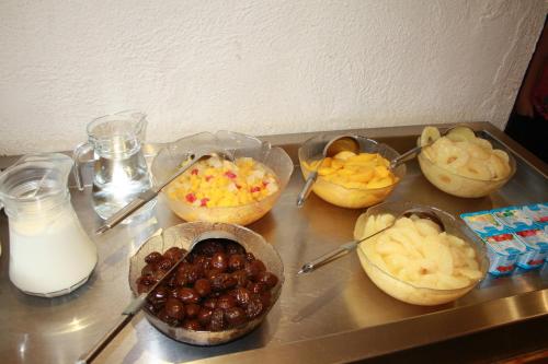 a table topped with different types of food in bowls at Sandyford Hotel in Glasgow