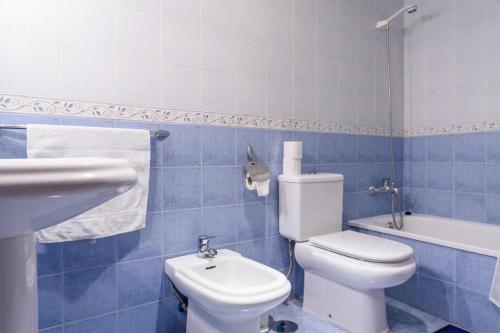 馬托斯的住宿－Céntrico Alojamiento，蓝色瓷砖浴室设有卫生间和水槽