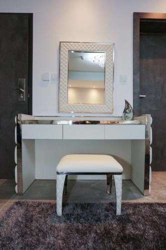 a dressing table with a mirror and a stool at J'Me Boutique Hotel - Adults only in St Julian's
