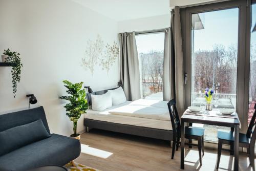 a bedroom with a bed and a table and a window at The Rix Studios & Suites near SBahn Neukölln in Berlin