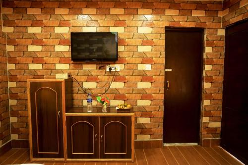 a brick wall with a television on top of it at Chitwan Forest Resort , Chitwan National Park in Sauraha