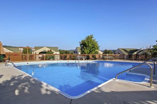 a large swimming pool with blue water at Penthouse w Lake View & private deck- next to SDC in Branson