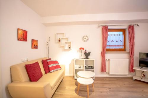 a living room with a couch and a table at Alpenliebe Ferienwohnung in Ofterschwang