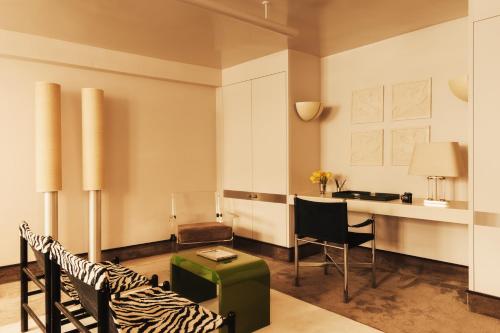 a living room with a desk and a zebra chair at Pied A Terre - Tuileries in Paris