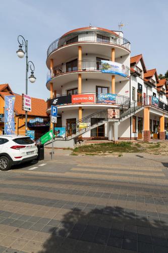 a white car parked in front of a building at Krab in Rewal