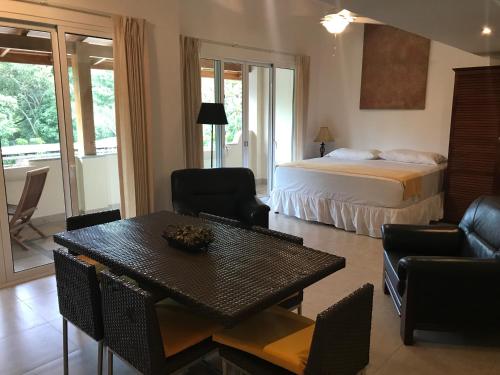 a hotel room with a bed and a table and chairs at Montelaguna Boutique Hotel in Sámara
