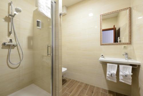 a bathroom with a shower and a sink and a toilet at Pension Relish in Rajecké Teplice