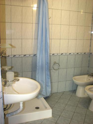 a bathroom with a sink and a toilet and a shower at Hotel SOLE in Primorsko