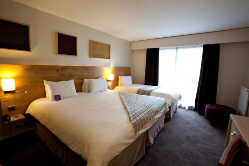 a hotel room with two beds and a window at Mercure Saint-Lary in Saint-Lary-Soulan